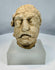 Carved limestone Bodhisattva head from ancient Gandhara with weathered facial features and archaeological surface patina.