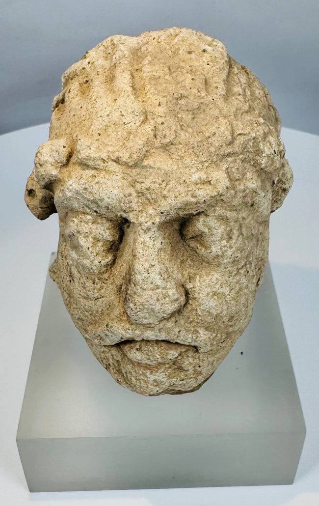 Silk Road era Gandharan Buddhist sculpture fragment carved from limestone and preserved with authentic archaeological wear.