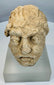 Silk Road era Gandharan Buddhist sculpture fragment carved from limestone and preserved with authentic archaeological wear.
