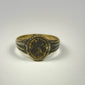 Ancient Near Eastern bronze signet ring with ornate floral motif and aged patinated finish