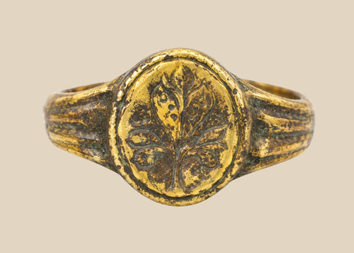 Late Roman to Early Byzantine gold-gilded bronze ring, circa 300–600 CE, with engraved floral bezel, worn gilding, and authentic patina.