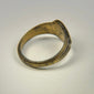 Ancient bronze signet ring with floral engraving, worn gilded surface, and slender band