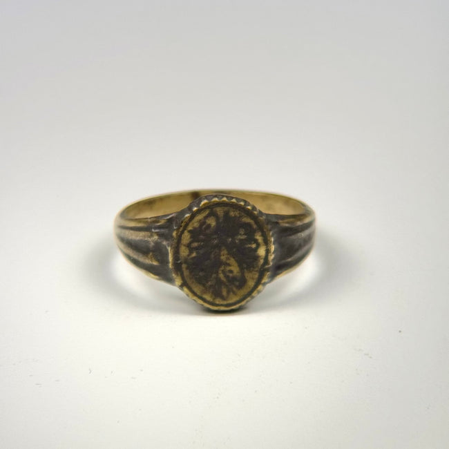 Historic gold-gilded bronze ring dating to circa 300–600 CE with engraved botanical decoration