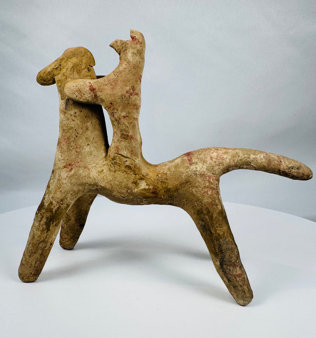Greek terracotta horse and rider figurine with abstract geometric styling characteristic of Boeotian workshops.