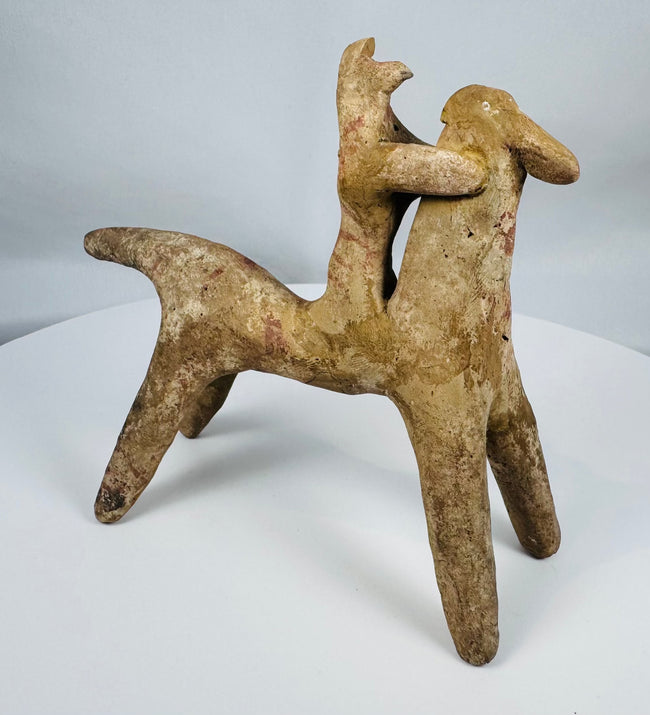 Boeotian terracotta horse and rider votive sculpture from ancient Greece with traces of original red pigment.