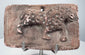 Ancient terracotta plaque from India with probable leopard figure, impressed coat markings, and central age crack.