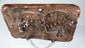 Mould-made Indian terracotta animal plaque with raised feline figure and salmon-pink ceramic fabric.