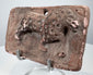 Antique Indian terracotta animal plaque with raised feline figure, rounded corners, and historic surface deposits.