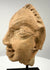 Three-quarter view of antique terracotta head displaying nose, mouth, and ear details
