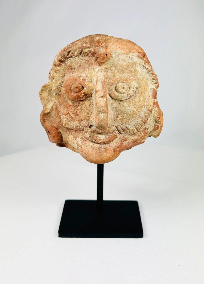 Front view of an ancient Indian terracotta head crafted in red clay during the Shunga period