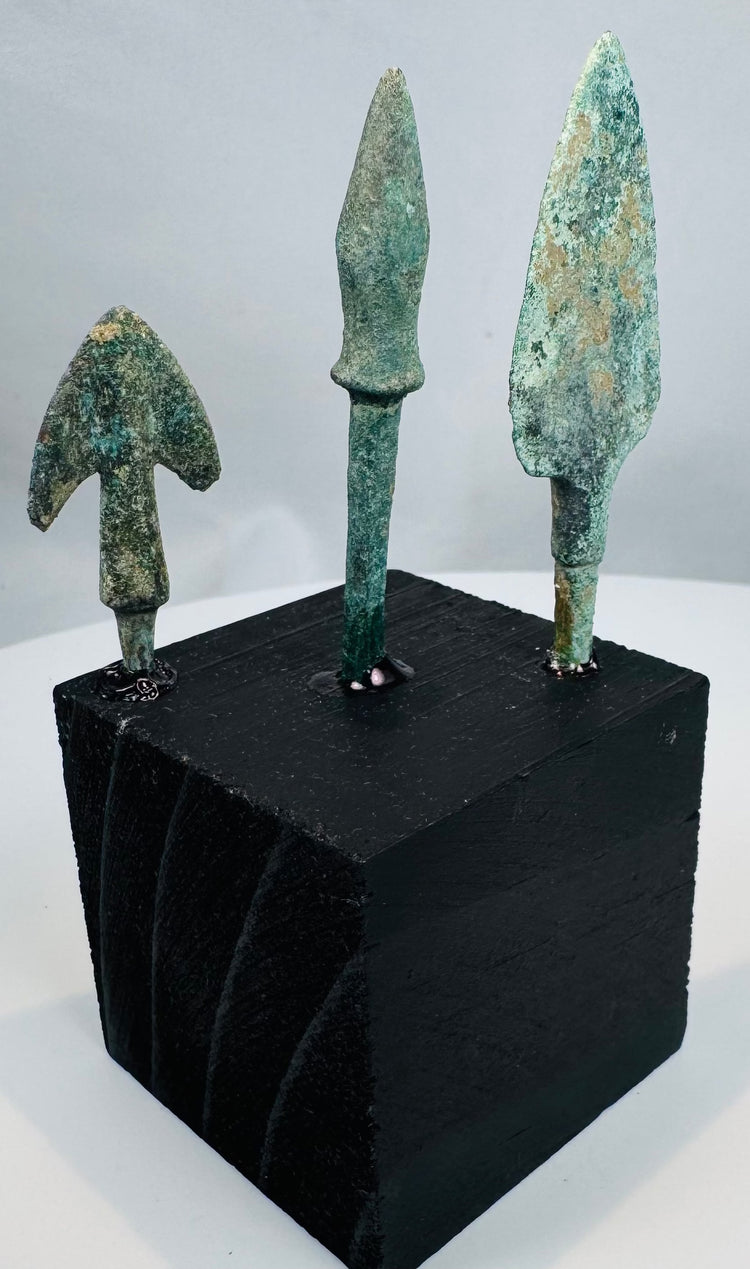 Compact winged bronze arrowhead with swallow-like shoulders and heavy mineral patination