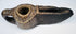 Ancient Islamic stone oil lamp with hand-carved geometric motifs, open wick spout, and naturally aged surface patina.