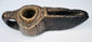 Ancient Islamic stone oil lamp with hand-carved geometric motifs, open wick spout, and naturally aged surface patina.