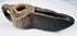Early medieval Islamic stone oil lamp with geometric ornamentation, functional wick opening, and historic patina.