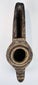 Hand-carved Middle Eastern stone lamp with abstract geometric decoration and an elongated spout for burning oil.