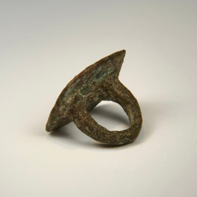 Bronze finger ring with paired bird motif, softened bezel edges, and age-related surface wear