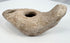 Late antique ceramic oil lamp with mineral deposits and weathered surface