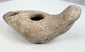 Late antique ceramic oil lamp with mineral deposits and weathered surface