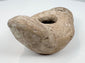 Historic Mediterranean oil lamp showing encrustation and age-related wear