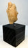 Profile view of ancient terracotta face with strong chin and nose