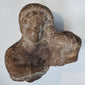 Authentic terracotta bust fragment with stylized facial features from the Classical Mediterranean world.