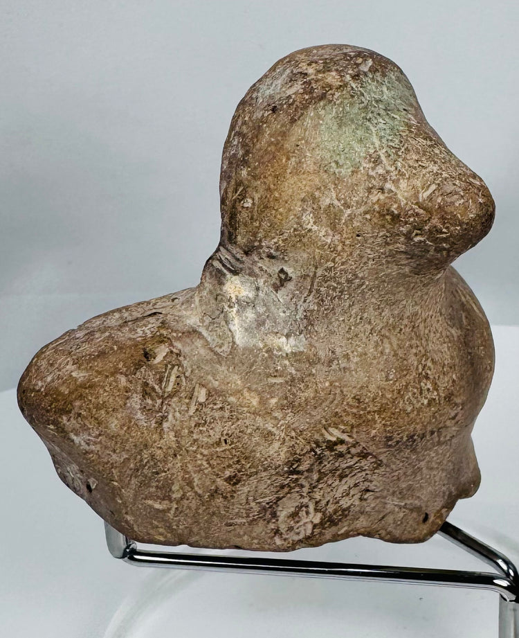 Classical Mediterranean earthenware bust fragment featuring almond-shaped eyes and softly modeled facial features.