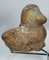 Classical Mediterranean earthenware bust fragment featuring almond-shaped eyes and softly modeled facial features.