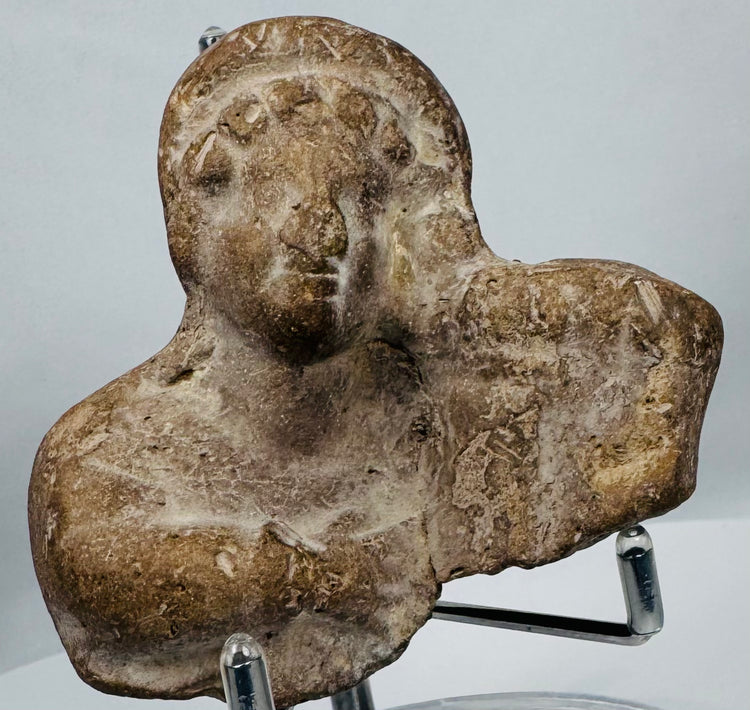 Ancient terracotta devotional figurine fragment with hollow mold-made construction and surviving upper torso.