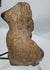 Rear view of an ancient mold-made terracotta figural fragment showing hollow ceramic construction.