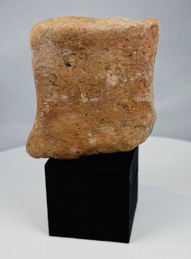 Hellenistic or Roman provincial plaque fragment mounted on a black display stand