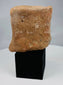 Hellenistic or Roman provincial plaque fragment mounted on a black display stand