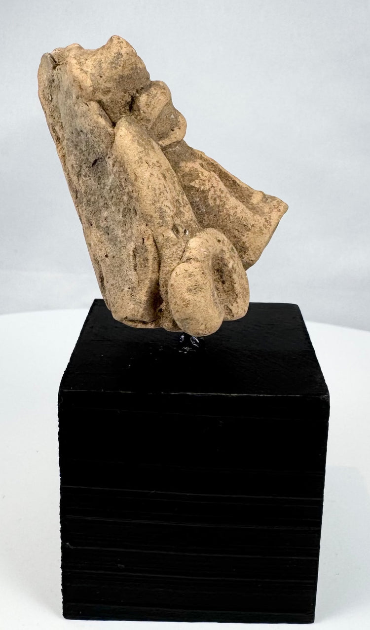Pre-Columbian carved tan stone head displaying archaeological wear and surface patina
