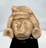 Pre-Columbian stone head depicting an elite figure with earspools and ceremonial headdress