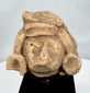 Pre-Columbian stone head depicting an elite figure with earspools and ceremonial headdress