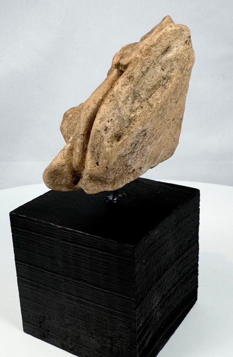 Ancient Mexican ceremonial stone fragment with prominent nose and circular ear ornaments