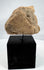 Mesoamerican carved stone sculpture fragment with downturned mouth and recessed eyes
