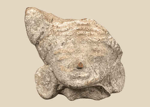 Pre-Columbian terracotta head fragment depicting a stylized human face with closed eyes and large ear ornaments.
