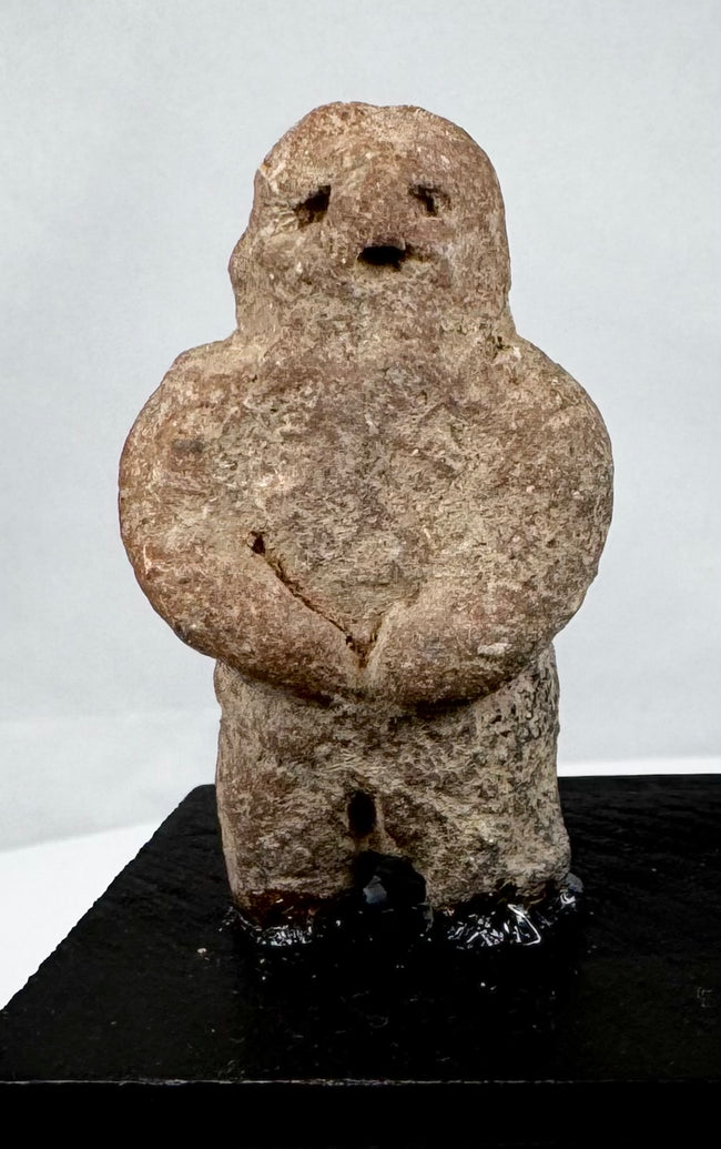 Ancient Mesoamerican stone effigy with abstract human form and weathered surface