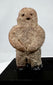 Ancient Mesoamerican stone effigy with abstract human form and weathered surface