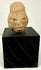 Frontal view of Ancient Mesoamerican terracotta head sculpture with elongated cranium and stylized features