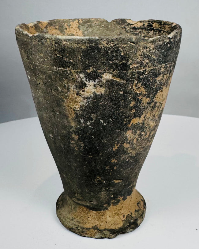 Iron Age ceramic cup with chipped rim and archaeological patina