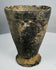 Iron Age ceramic cup with chipped rim and archaeological patina