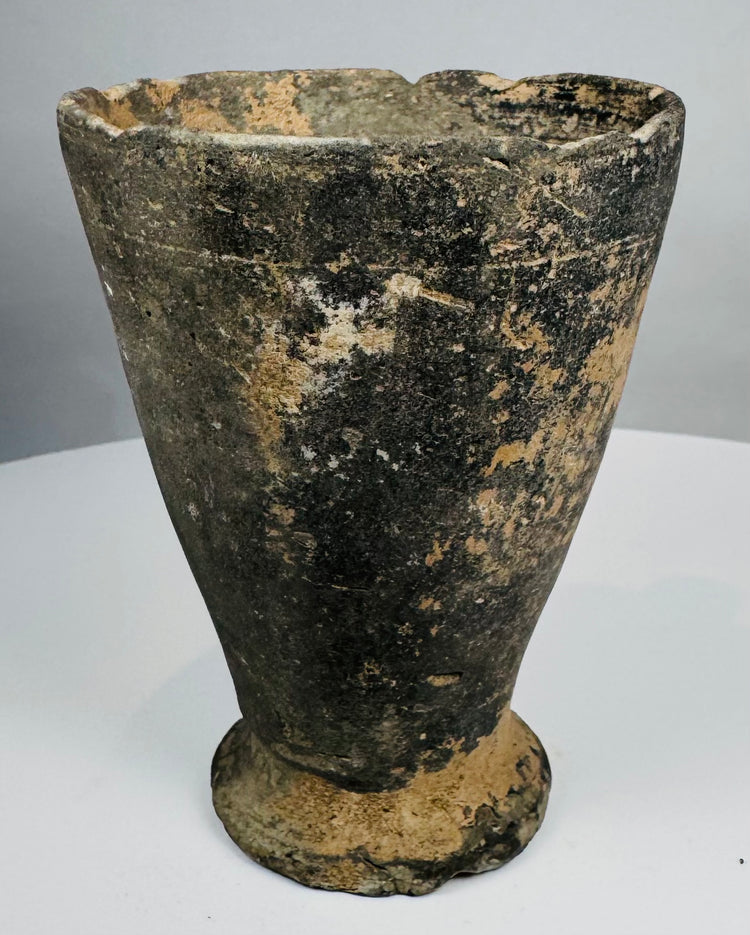 Iron Age ceramic cup with chipped rim and archaeological patina