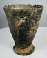 Iron Age ceramic cup with chipped rim and archaeological patina