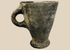 Ancient Near Eastern grayware pottery cup with flaring bowl and loop handle