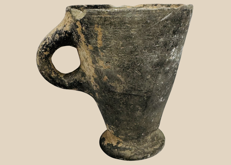 Ancient Near Eastern grayware pottery cup with flaring bowl and loop handle