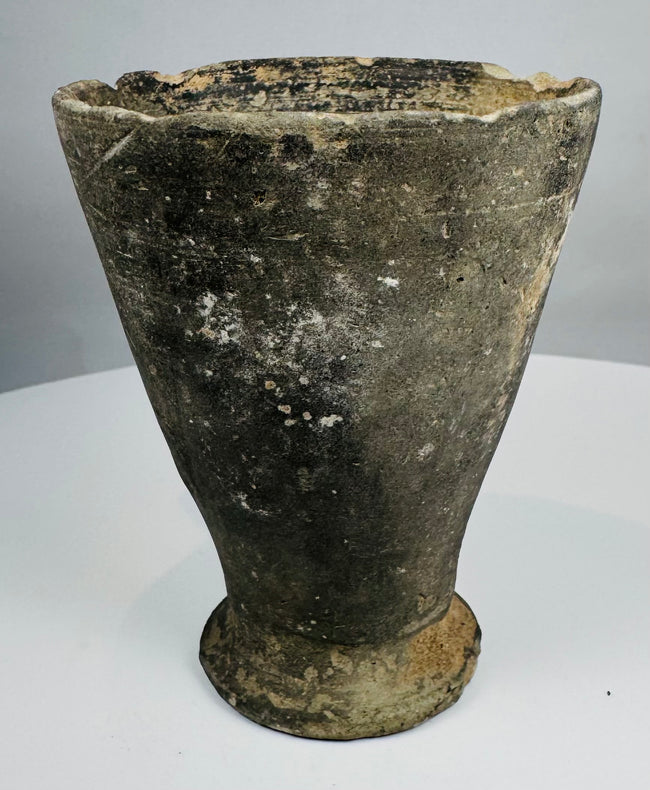Side view of Iron Age pottery cup showing large applied loop handle