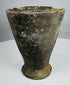 Side view of Iron Age pottery cup showing large applied loop handle