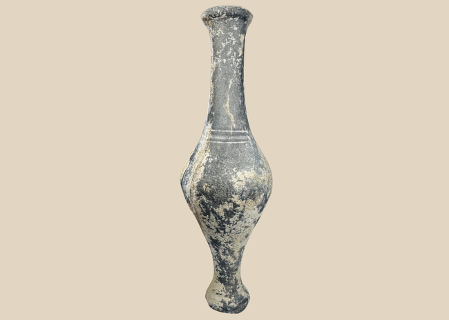 Ancient Iranian grayware spindle bottle with long neck and pedestal foot