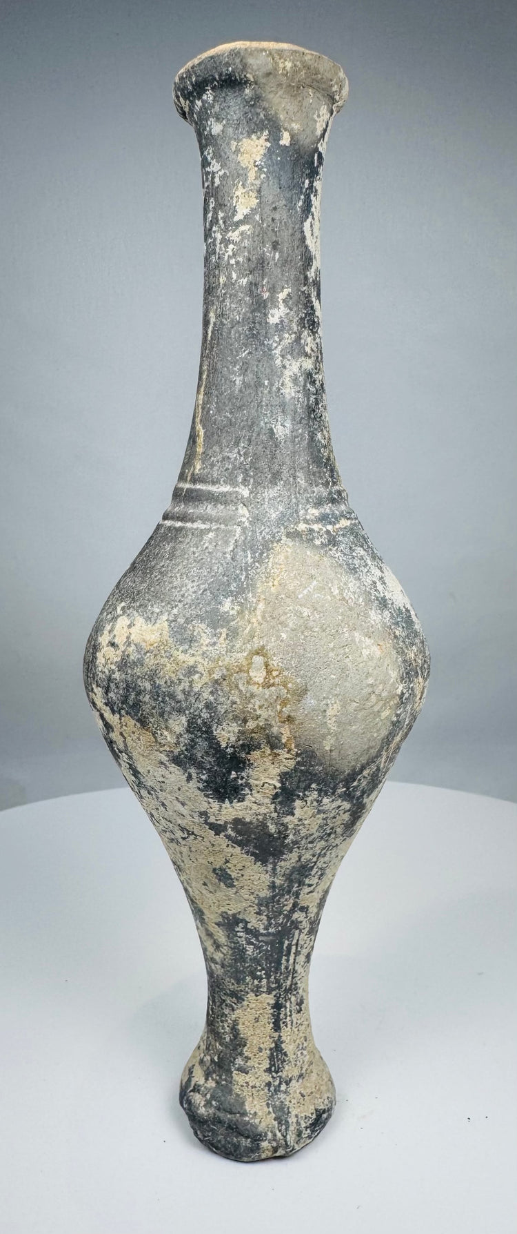 Ancient grayware bottle with globular body and narrow elongated profile